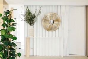 A white door with a decorative metal plate, a white wall with vertical slats, and a potted plant with green leaves. - Luxurious Villa Ksenia with Pool Murter (Murter)