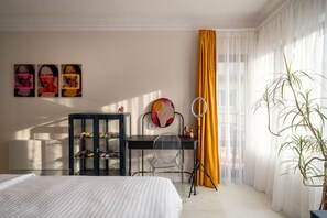 A hotel room with a bed, a desk with a ring light, a mirror, and a plant. - NEW! Pink Lipstick Lounge Design look/Hotel feel (Sofia)