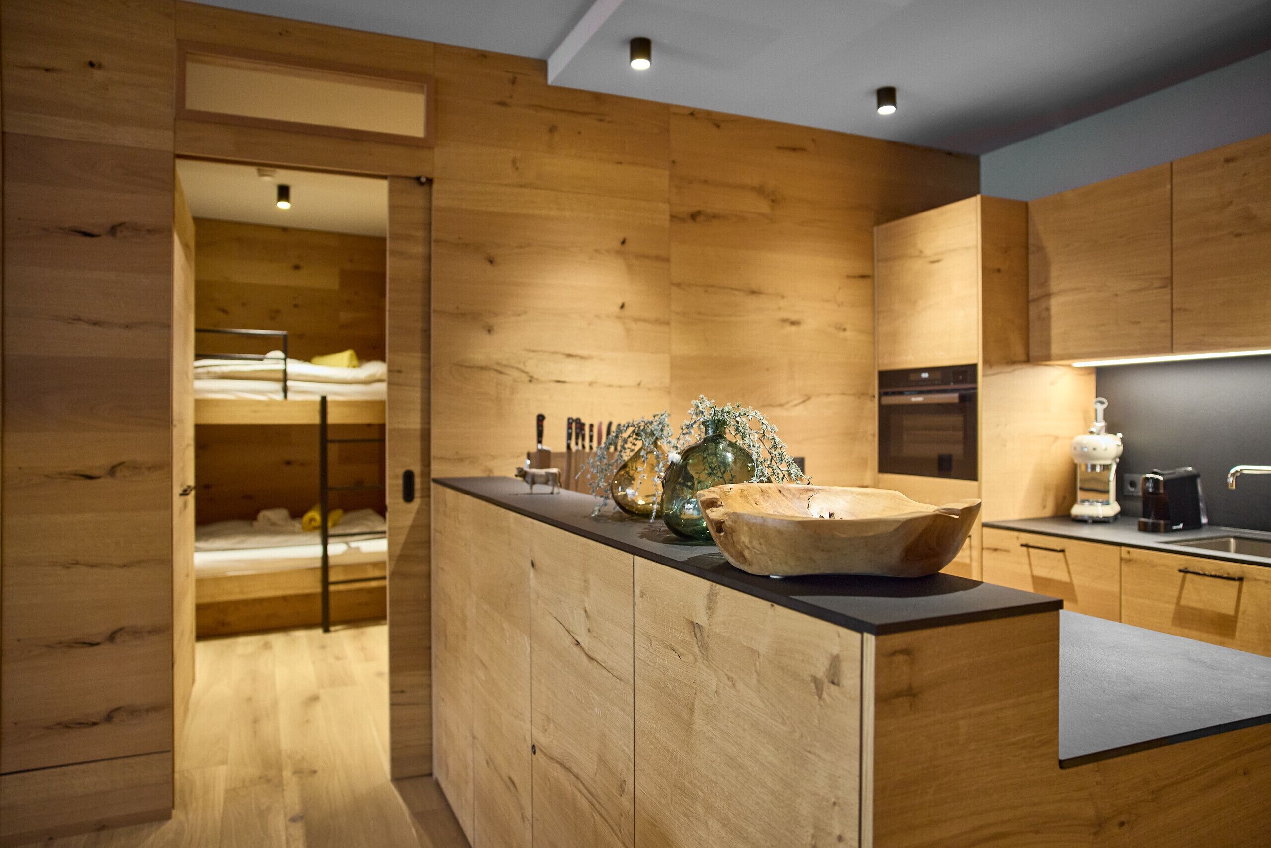 A modern kitchen with wooden cabinetry and a central island.