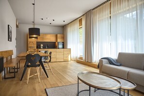 A modern living space with a kitchen, dining area, and seating area. - 8009 Arlberg Grand Residence 9 (Schröcken)