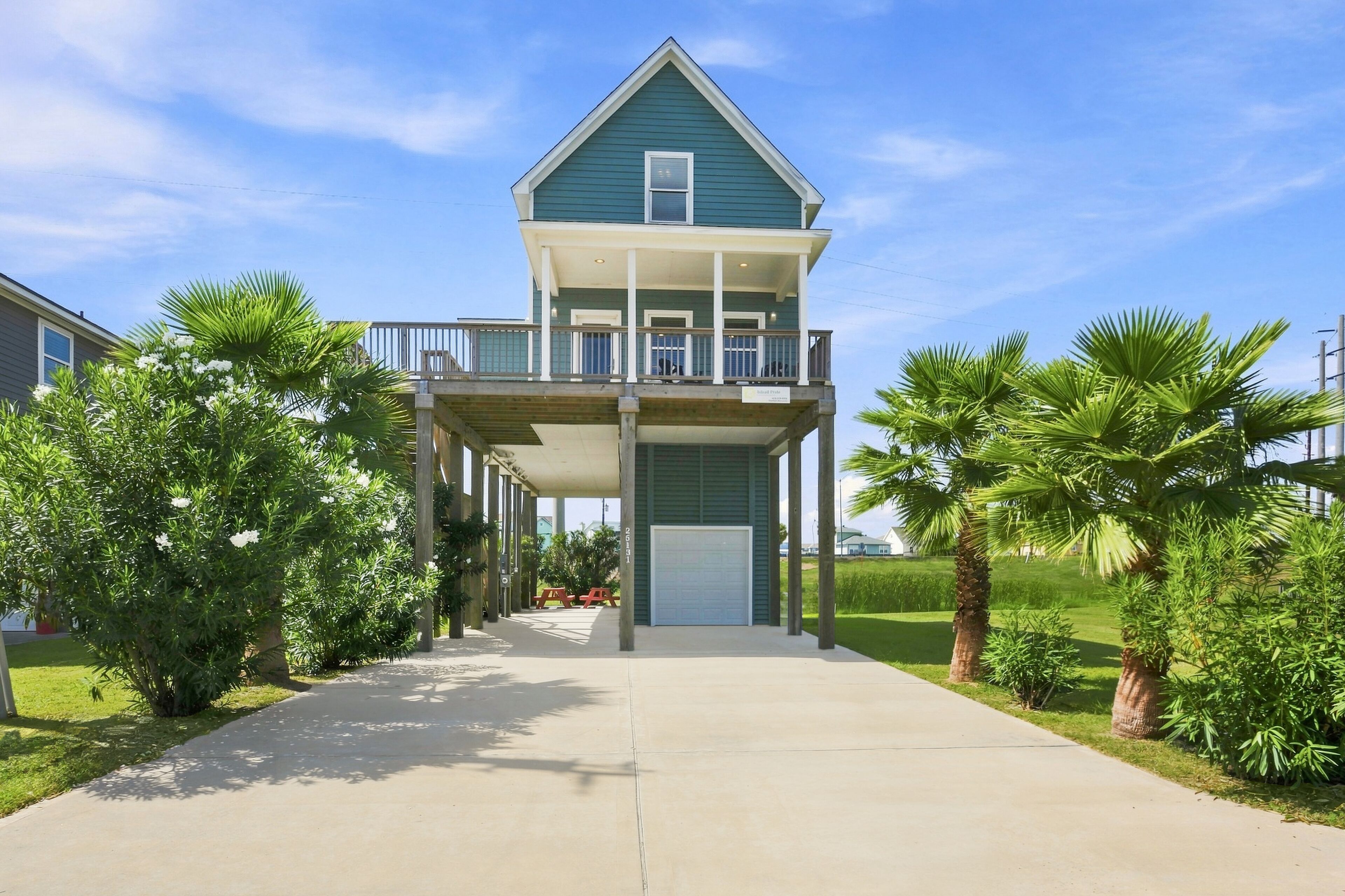A two-story house with a covered porch and a garage.