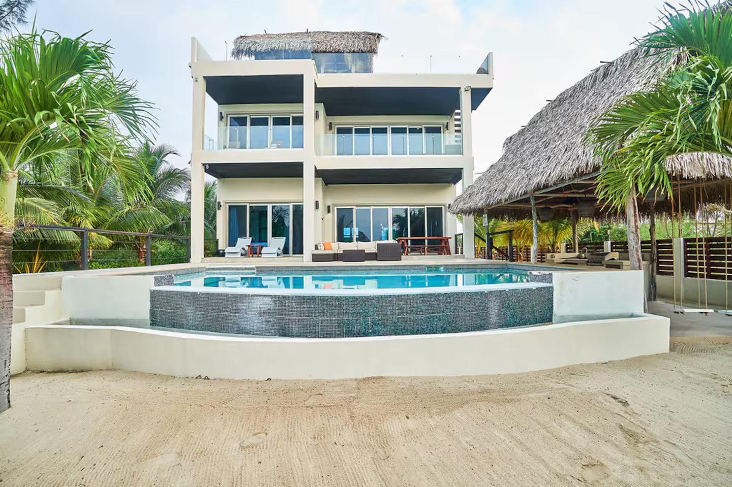 A two-story building with a swimming pool in front.