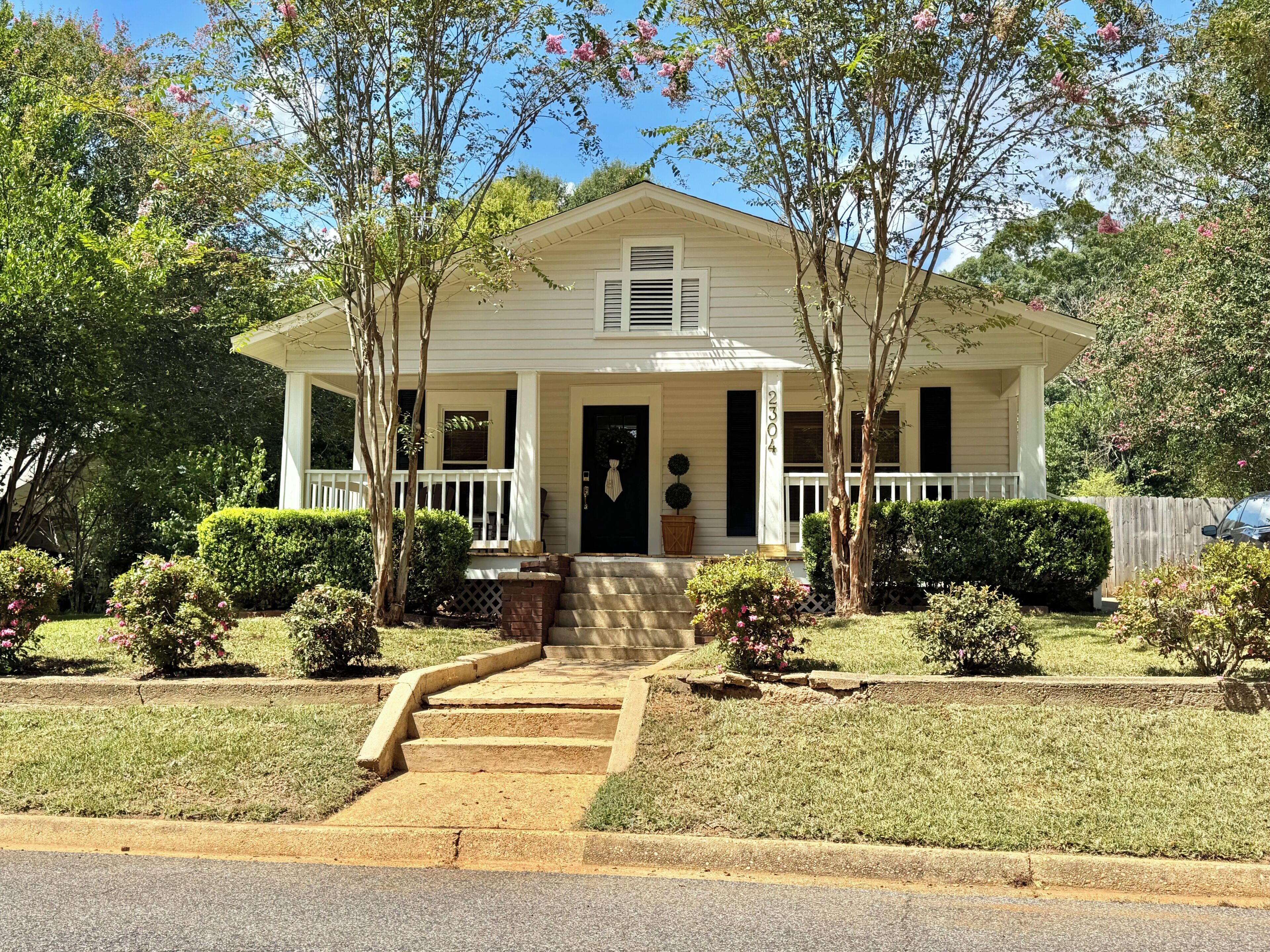 A two-story house with a front porch, a mailbox, and a number 2304 on the door.