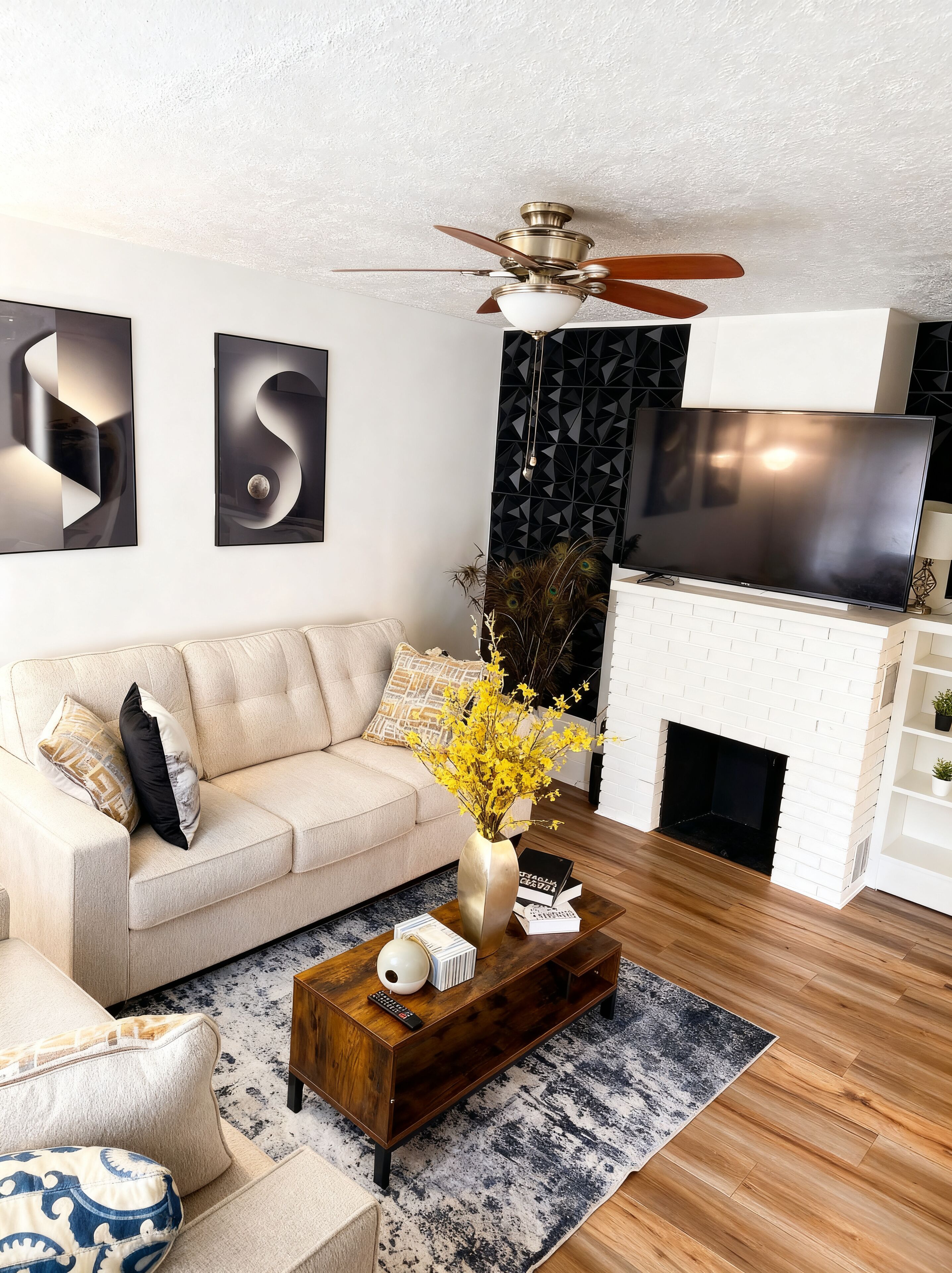 A modern living room with a sofa, coffee table, and a fireplace.