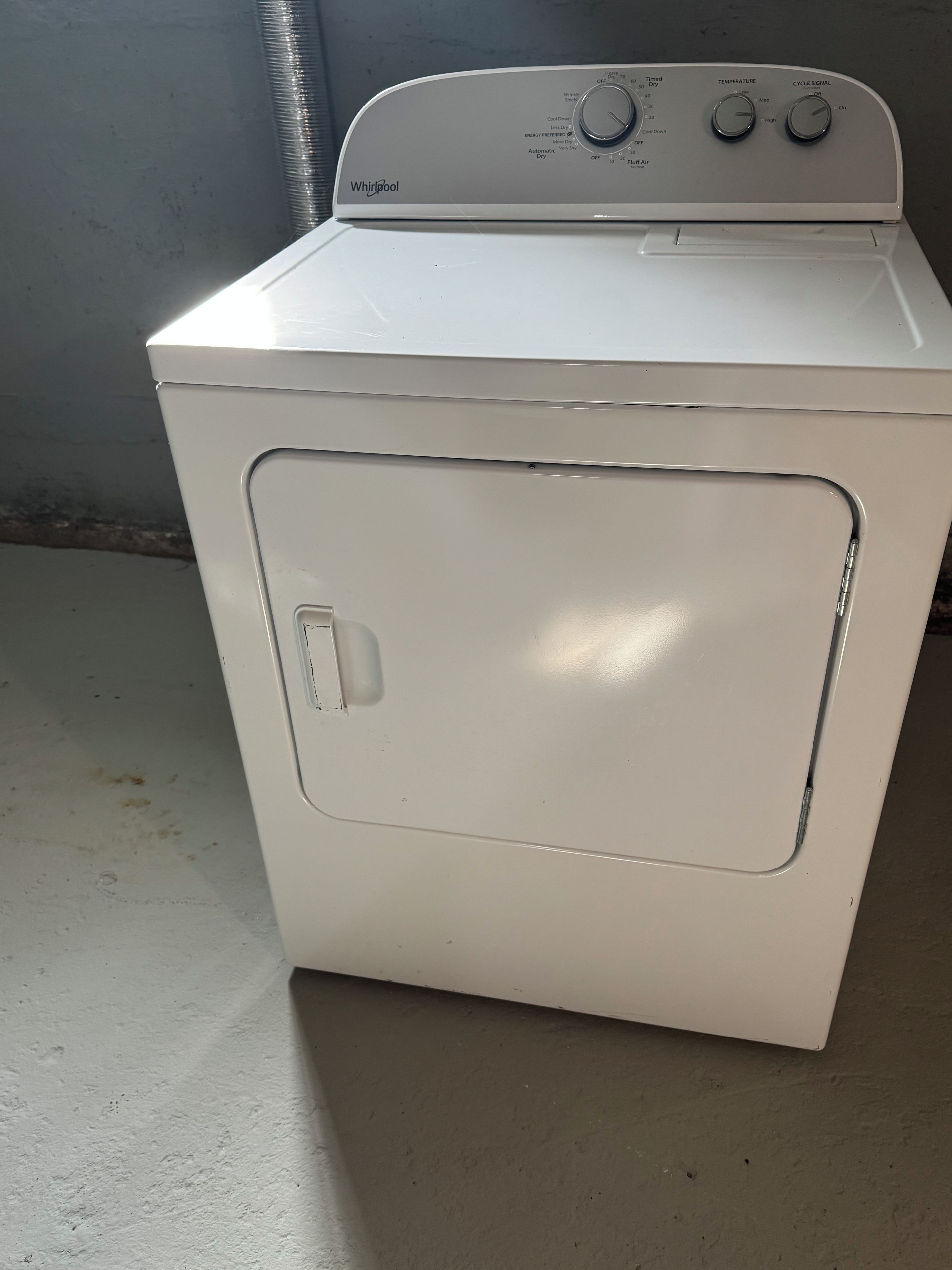 A white Whirlpool washer with a control panel, a front door, and a vent on top.