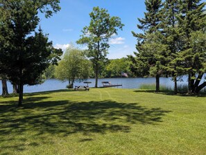 A lakeside park with picnic tables and a flag. - Eagle's Nest On The Water (Butternut)