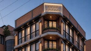 A multi-story building with a sign reading 'EDIFICIO ESPERANZA' at the entrance. - Centrally Located, Fully Furnished Apartment with Support Services and Close to Everything! (Tarija)