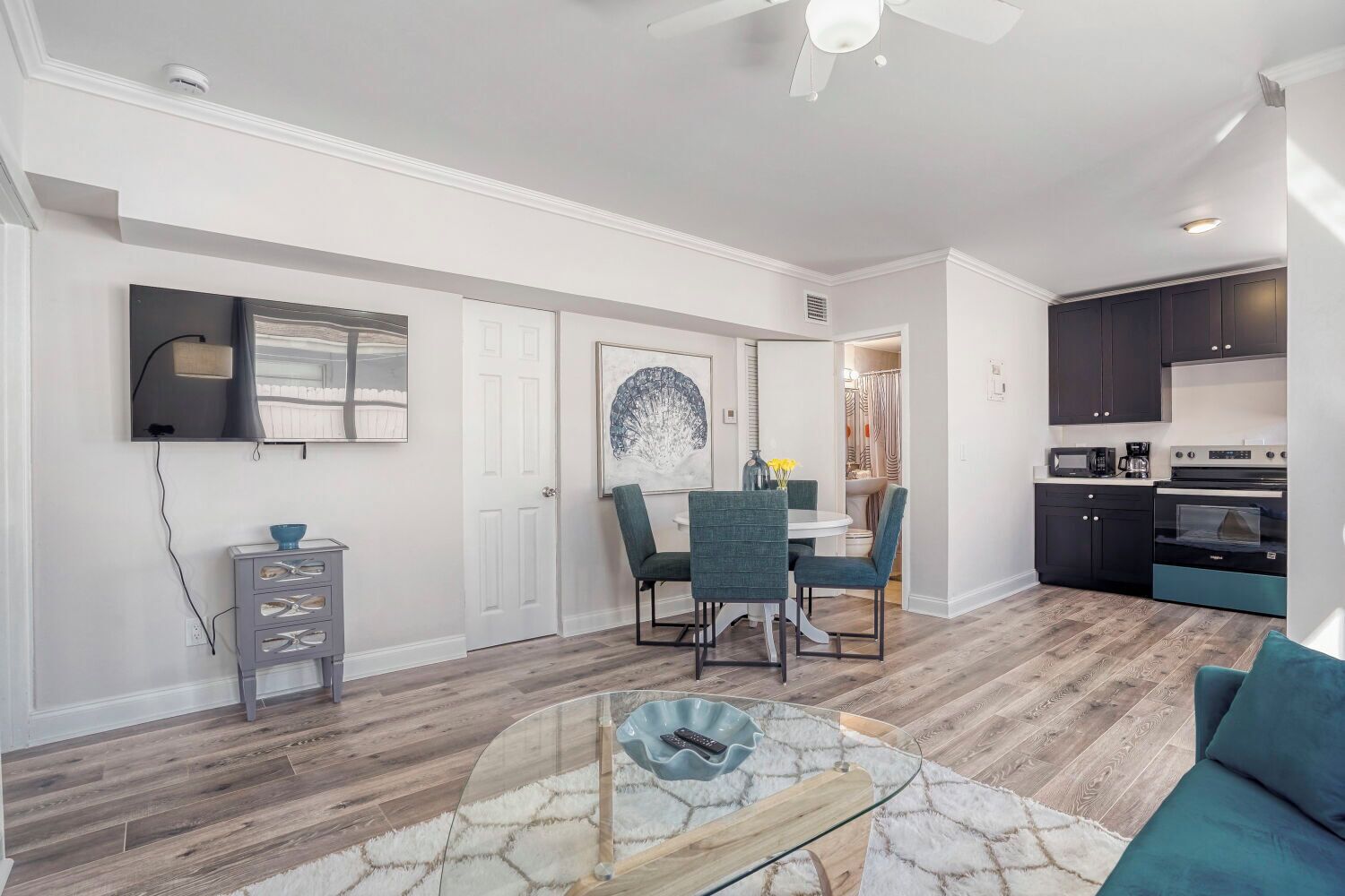 A modern kitchen with dark cabinets, a microwave, and a stove.