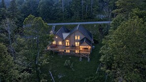A two-story house with a deck and a staircase leading to a second level. - Kumbaya House: Steps from Cupp Run | Hot Tub, Deck & Epic Sunset Views (Snowshoe)