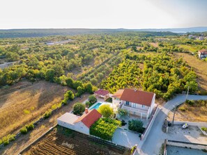 A residential property with a swimming pool, surrounded by a garden and a view of a hilly landscape. - Holiday Home Dinko with pool by Interhome (Pridraga)