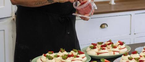 A person in a chef's uniform preparing food in a kitchen.
