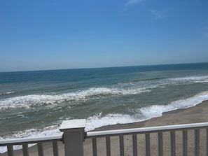 A beach view with waves, a clear sky, and a railing. - Tent in Leland perfect for your outdoor getaway (Leland)