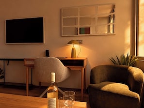 A room with a desk, a chair, a bottle of wine, and a plant. - Blue Elegant Suite (Thessaloniki)