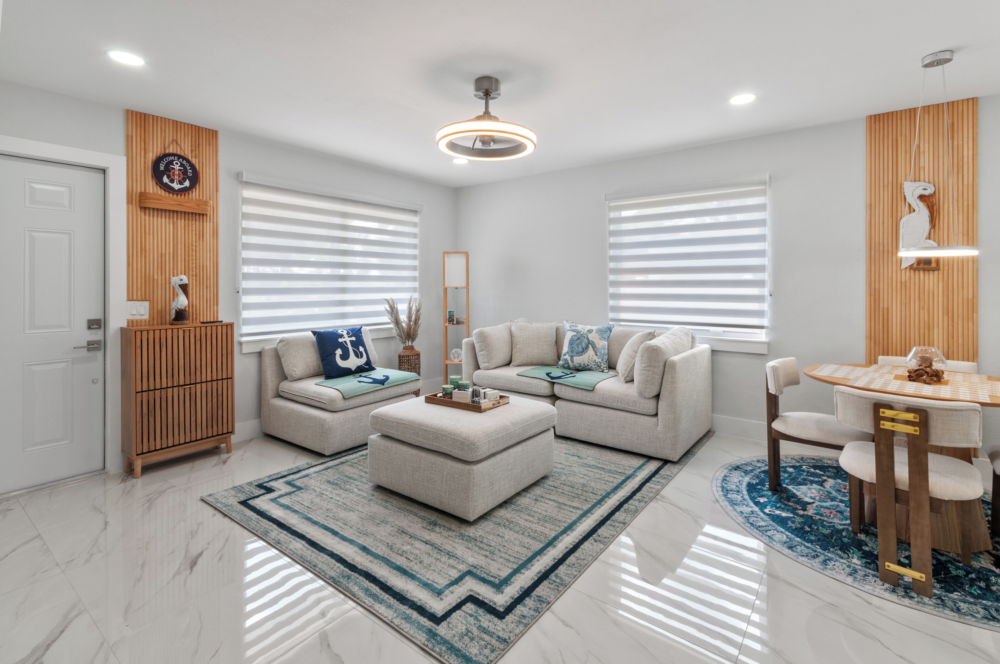 A modern living room with a sofa set, a coffee table, and a dining area with a table and chairs.