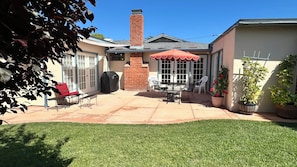 A backyard patio with a barbecue grill, outdoor furniture, and a lawn. - Bay Ho Retreat—Sleeps 9—5-Minutes to La Jolla, Pacific Beach, Bay & Trolley (San Diego)