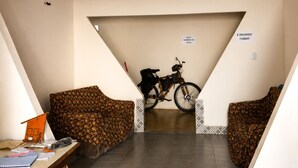 A staircase leading to a lower level with a bicycle parked against the wall.