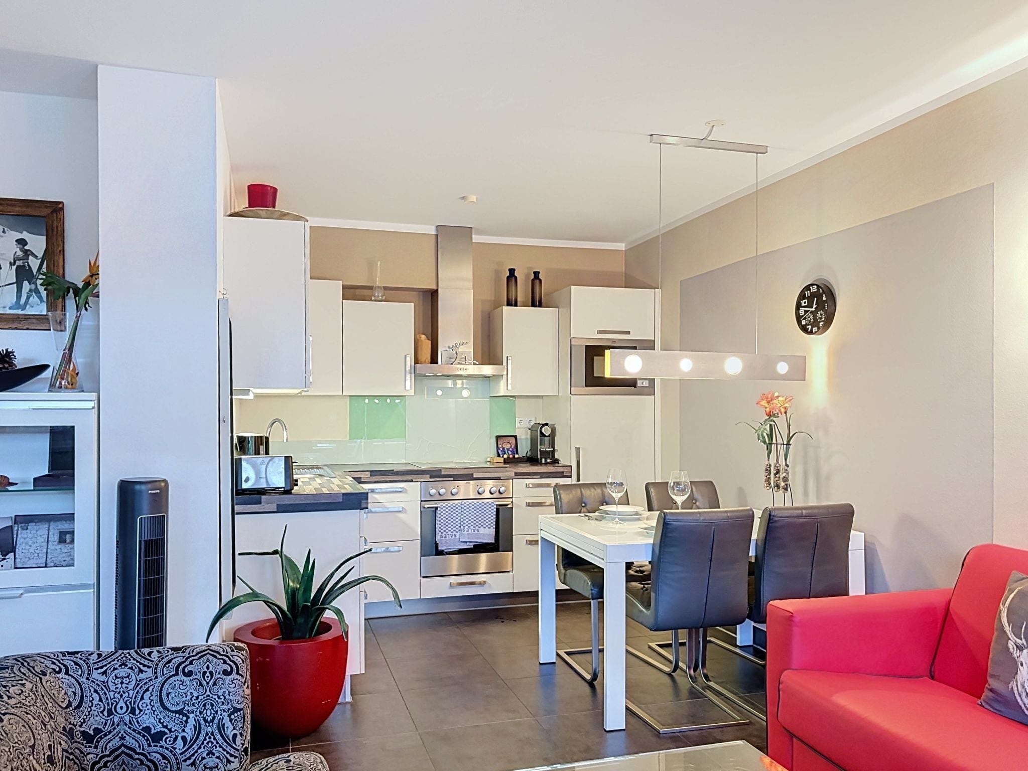 A modern apartment with a kitchen, dining area, and living room.