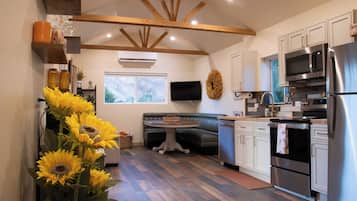 A modern kitchen with a built-in oven, microwave, and refrigerator.