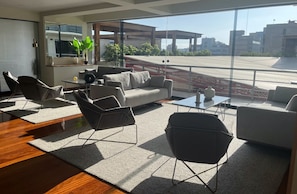 A modern living room with a sofa, armchairs, and a coffee table. - Cozy 1-bedroom 80m2 apartment in Miraflores with pool (Miraflores)