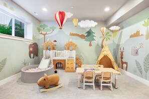 A children's playroom with a slide, playhouse, and a tent. - Spacious Kirkland Home Near Microsoft & Google (Kirkland)