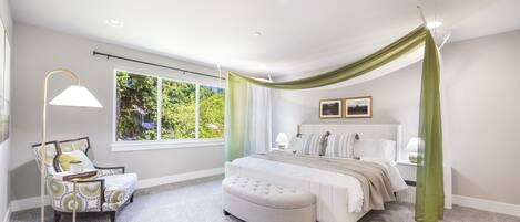 A bedroom with a large window, a bed with a canopy, a chair, and a floor lamp.