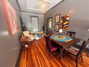 A dining area with a wooden table, chairs, and a blue placemat.
