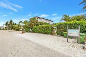 A beachfront property with a sign indicating 'Lido Beach House' and a gated entrance. - Sunny Lido Beach Studio (Sarasota)