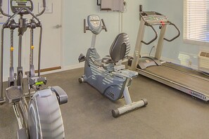 A fitness center with cardio machines, including a stationary bike and a treadmill. - Dolphin Beach Club - 1 Bedroom Condo (Daytona Beach Shores)