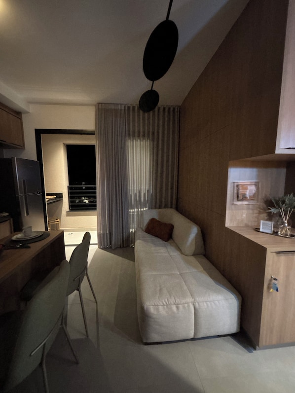 A modern bedroom with a bed, a desk, and a chair.