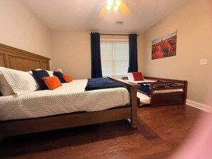 A bedroom with a bed, a desk, and a window with curtains. - Spacious 3 Bed 3 Bath Tiger Den – 1 Mile to AU! (Auburn)
