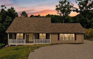 A single-story house with a front porch, a garage, and a driveway.