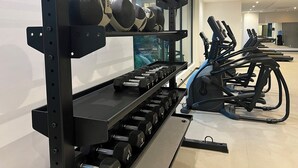 A gym with weightlifting equipment and treadmills. - Studio Apartment  (Accra)