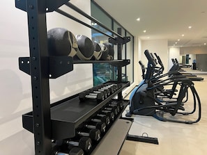 A gym with weightlifting equipment and treadmills. - Studio Apartment  (Accra)