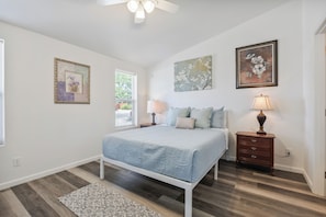 A bedroom with a bed, nightstands, a ceiling fan, and artwork on the walls. - West Sedona Retreat - Near Trails & Red Rocks (Sedona)