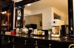 A kitchen counter with a coffee maker, a toaster, and various kitchen items.