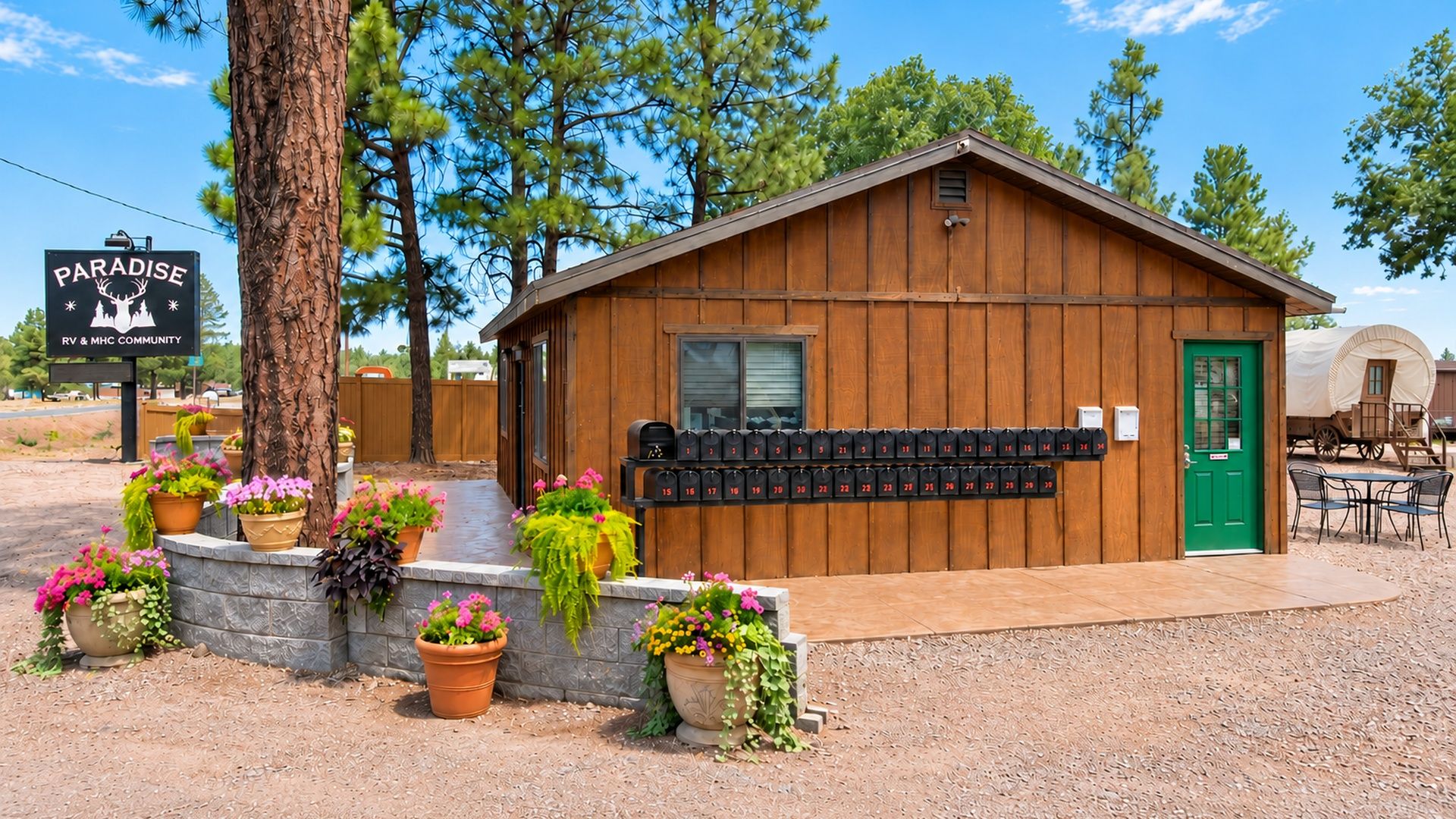 A wooden cabin with a mailbox, surrounded by potted plants and a sign for Paradise RV & MHC Community.