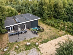 A modern house with a flat roof, a swimming pool, and a patio with outdoor furniture. - "Carlina" -  from the sea by Interhome (Hadsund)