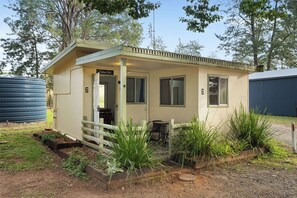 A small, single-story building with a covered porch and a door labeled 'Cabanas St.'