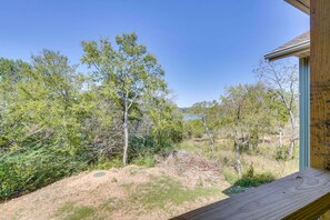 A wooden deck with a view of a natural landscape including trees and a body of water. - Lakeside 2BR Cabin Table Rock Lake - Sunset Views (Eagle Rock)