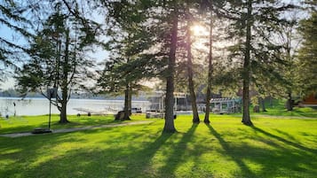 A park with a lake, trees, and a playground.