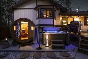 A spa area with a hot tub, a wooden barrel, and a sauna. - Cabin vibe & Lux comfort, Sauna~Hot Tub~Game Room~Fire Pit~Pet friendly (Big Bear Lake)