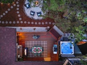 An outdoor patio with a hot tub, seating area, and a fire pit. - Cabin vibe & Lux comfort, Sauna~Hot Tub~Game Room~Fire Pit~Pet friendly (Big Bear Lake)