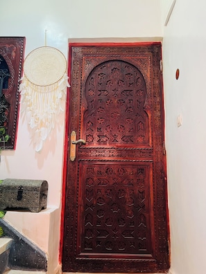 A wooden door with intricate carvings and a decorative handle. - We Host 212 l Every Stay in Marrakech Worth Repeating (Marrakesh)