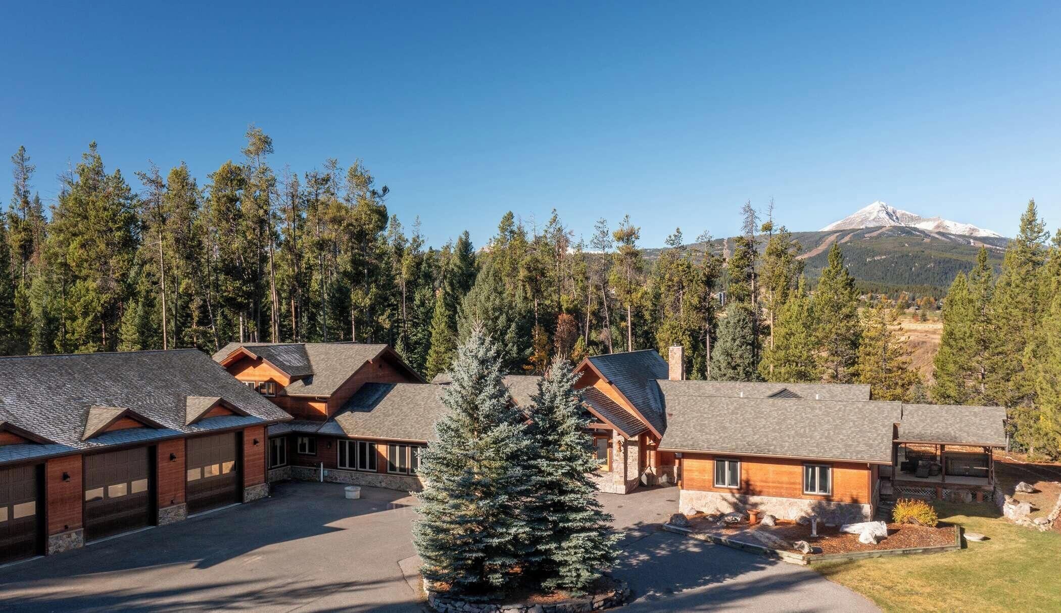 A lodge with multiple cabins, a central building, and a mountain backdrop.