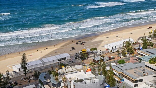 A coastal area with a beach, buildings, and a road. - Luxurious 2BD Ocean View w/ Pool, Gym, Spa & Sauna (Surfers Paradise)