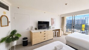 A hotel room with a bed, a TV, a desk, and a view of the city. - Stylish Hotel Room | near Beach and Tram | Max 4 (Surfers Paradise)