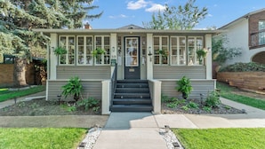 A two-story house with a front porch, a staircase, and a mailbox.