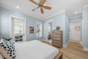 A bedroom with a bed, a ceiling fan, a dresser, and a window with blinds. - Hot Tub~1/2 Mi to Beach~Outdoor Fireplace~Dogs OK (Santa Rosa Beach)