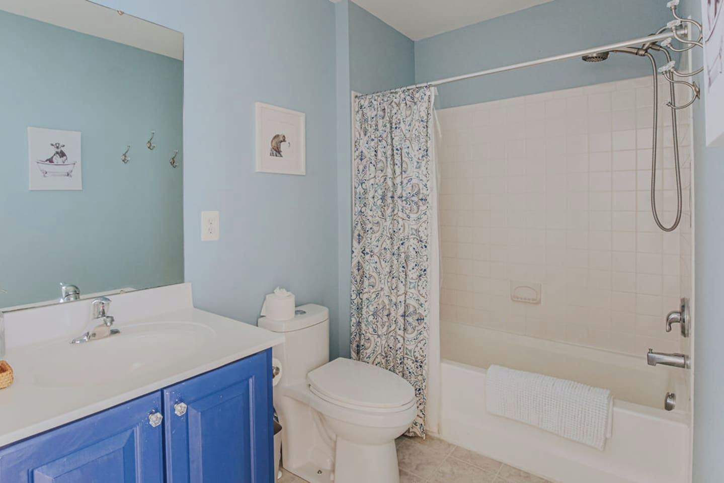 A bathroom with a bathtub, toilet, and sink.