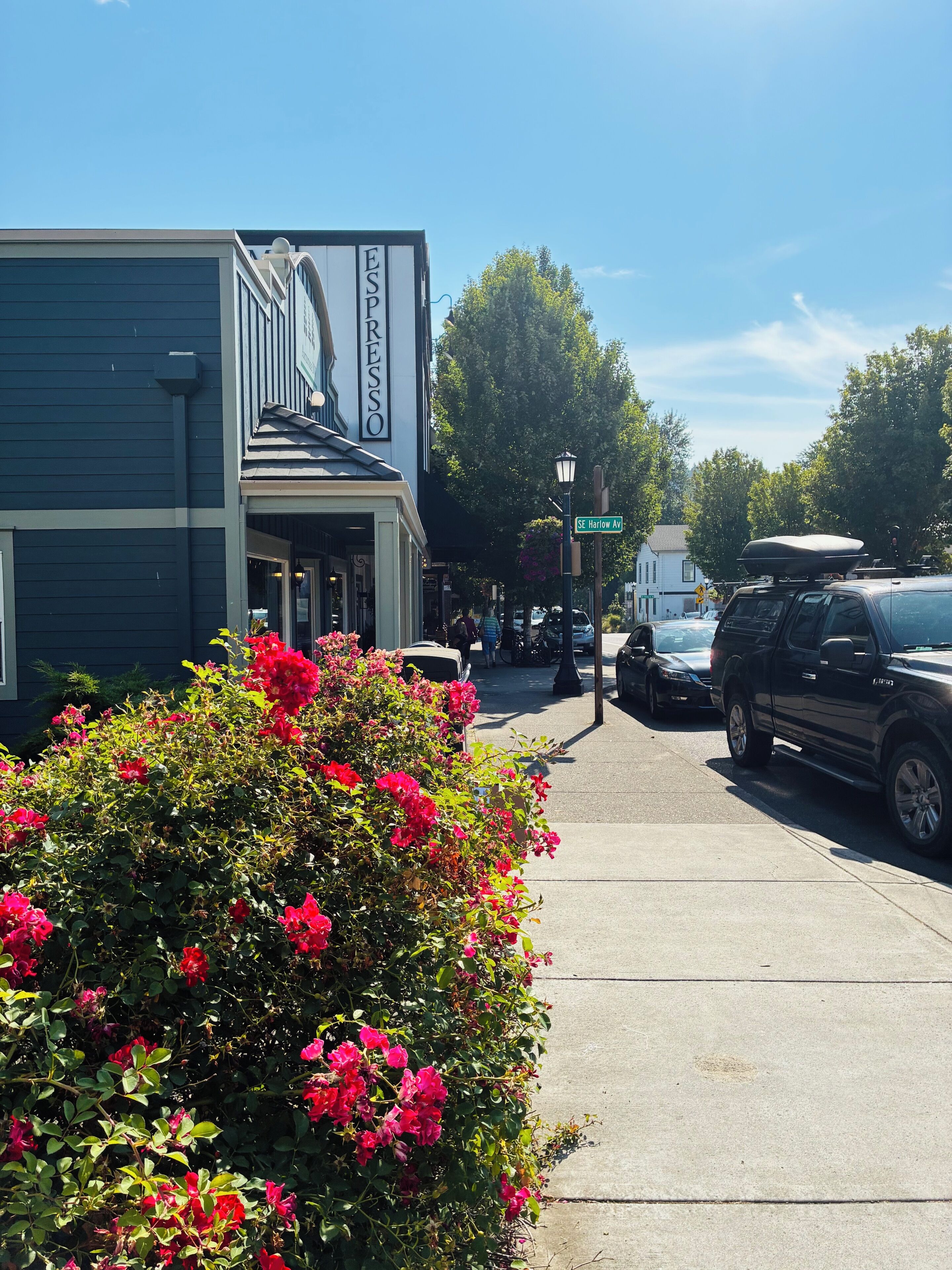 A street view with a building labeled 'ESPRESSO' and a street sign for 'SE Harlow Ave.'